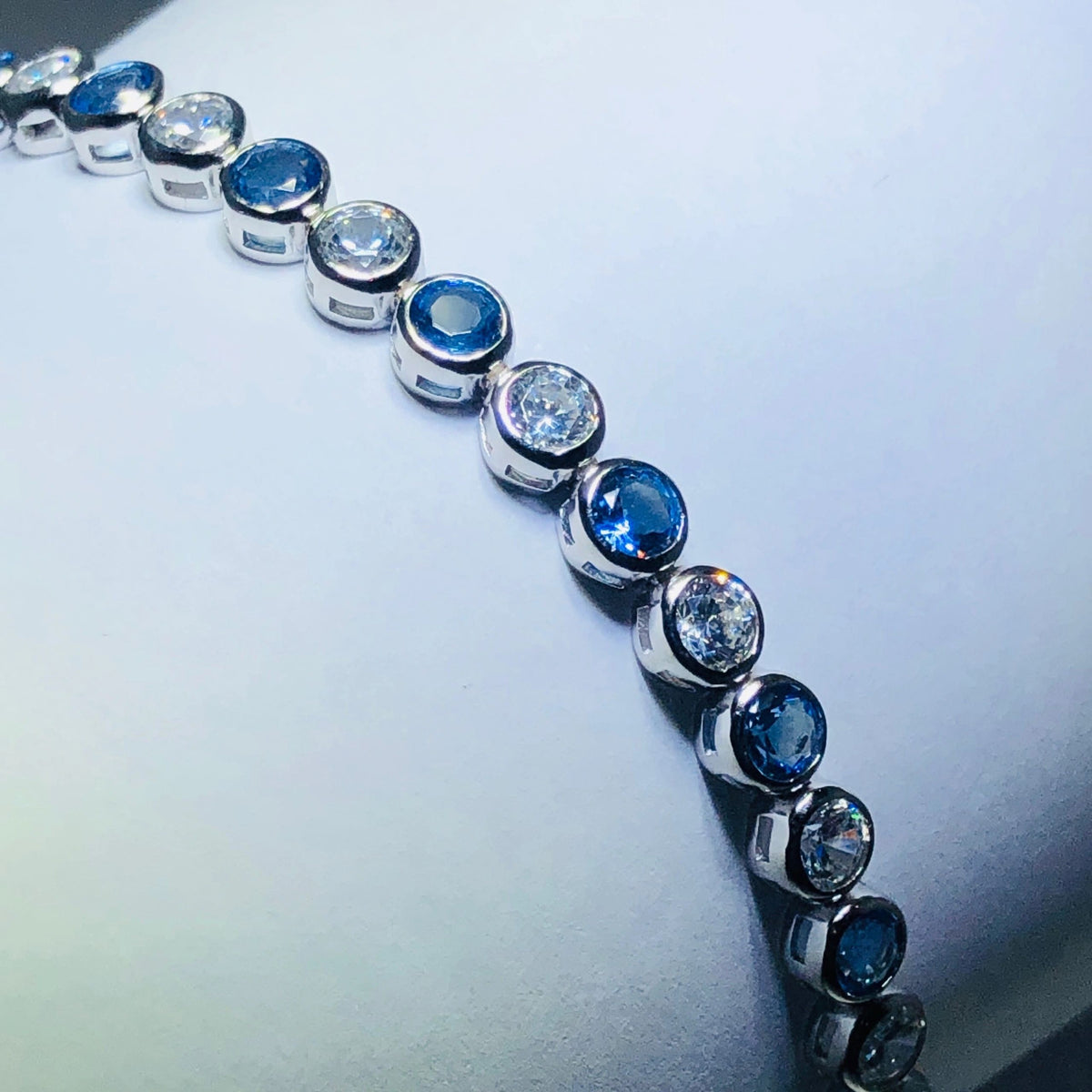 LIV platinum over sterling silver blue & white sapphire tennis bracelet